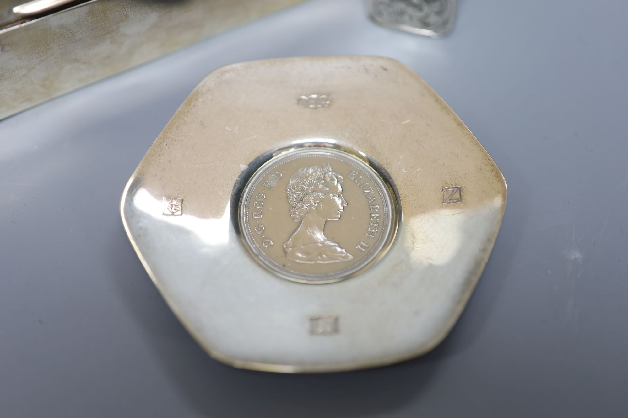 A silver cigarette box (marks rubbed), 14cm, a modern silver commemorative dish and a silver vesta case.